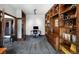 Bright home office featuring custom built-in wood bookshelves and storage, with lots of light from multiple sources at 12570 W 60Th Ave, Arvada, CO 80004