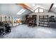 Versatile bonus room featuring skylights, a music area with guitars, and a dedicated workspace with built-in shelving at 12570 W 60Th Ave, Arvada, CO 80004