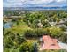 Scenic aerial view of the property showcasing the home, lush green landscape, and mountain views beyond at 12570 W 60Th Ave, Arvada, CO 80004