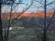 Picturesque view of mountains in the distance framed by trees, with a small pond visible in the foreground at 12570 W 60Th Ave, Arvada, CO 80004