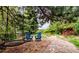 Cozy backyard seating area with swing and comfortable blue Adirondack chairs at 12570 W 60Th Ave, Arvada, CO 80004