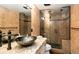 Elegant bathroom featuring vessel sink on granite countertop and glass-enclosed shower with tile surround at 12570 W 60Th Ave, Arvada, CO 80004