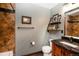 Bathroom featuring wooden vanity and modern wall decor at 12570 W 60Th Ave, Arvada, CO 80004
