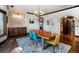 Inviting dining room with rustic wood table, accent wall with serving buffet, and hardwood floors for a cozy atmosphere at 12570 W 60Th Ave, Arvada, CO 80004