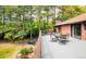 Outdoor dining set on a spacious back deck surrounded by lush trees and views of the yard at 12570 W 60Th Ave, Arvada, CO 80004