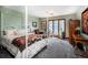 Comfortable bedroom with a four poster bed, large window with views, and a cozy sitting area with natural light at 12570 W 60Th Ave, Arvada, CO 80004
