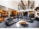 Expansive living room with a high ceiling, stone pillars, and a large sectional sofa at 12570 W 60Th Ave, Arvada, CO 80004