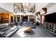 Expansive living room with a high ceiling, stone pillars, and a large sectional sofa at 12570 W 60Th Ave, Arvada, CO 80004