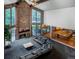Open-concept living area with soaring ceilings, stone fireplace, and large windows at 12570 W 60Th Ave, Arvada, CO 80004