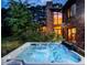 Relaxing hot tub with jets running located right off the main house surrounded by lush green landscaping at 12570 W 60Th Ave, Arvada, CO 80004