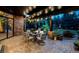 Outdoor patio with seating, brick walls, and string lights in a landscaped backyard at 12570 W 60Th Ave, Arvada, CO 80004