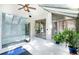Bright sunroom with glass ceiling, glass shower, tile floor, and lush green plants at 12570 W 60Th Ave, Arvada, CO 80004