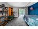 Spacious bedroom featuring a blue accent wall, a four poster bed, and a sliding glass door to a deck at 12570 W 60Th Ave, Arvada, CO 80004