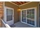 Exterior of a private balcony with a dark front door, sidelight and a sliding glass door at 1425 Blue Sky Cir # 15-107, Erie, CO 80516