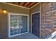Exterior of a private balcony with a dark front door and a sliding glass door at 1425 Blue Sky Cir # 15-107, Erie, CO 80516