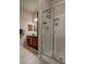 This bathroom features a wood vanity, granite countertop, modern sink and walk in shower at 1425 Blue Sky Cir # 15-107, Erie, CO 80516