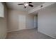 This carpeted bedroom features two entry doors and a modern ceiling fan at 1425 Blue Sky Cir # 15-107, Erie, CO 80516