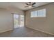Bedroom featuring sliding glass doors, neutral colored carpet and a ceiling fan at 1425 Blue Sky Cir # 15-107, Erie, CO 80516