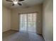 Cozy bedroom with neutral tones and a sliding glass door to a private balcony, enhanced with a ceiling fan at 1425 Blue Sky Cir # 15-107, Erie, CO 80516