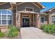 Charming community entrance with stone accents, manicured landscaping, and a welcoming double-door entry at 1425 Blue Sky Cir # 15-107, Erie, CO 80516