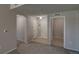 Spacious foyer with tile and carpet flooring featuring coat closet and arched doorway at 1425 Blue Sky Cir # 15-107, Erie, CO 80516