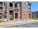 Beautiful condo complex exterior featuring stone accents and well-maintained landscaping at 1425 Blue Sky Cir # 15-107, Erie, CO 80516