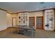 Spacious game room featuring a ping pong table, built-in shelving, and ample space for entertainment at 1425 Blue Sky Cir # 15-107, Erie, CO 80516