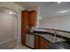 A well-lit kitchen with dark cabinets, granite countertops, and stainless steel appliances at 1425 Blue Sky Cir # 15-107, Erie, CO 80516