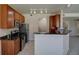 Well-equipped kitchen with stainless steel appliances, granite countertops, and hardwood cabinets at 1425 Blue Sky Cir # 15-107, Erie, CO 80516