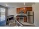 A kitchen with granite countertops and stainless steel appliances including a fridge, oven, and microwave at 1425 Blue Sky Cir # 15-107, Erie, CO 80516