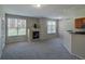 Bright open floorplan featuring a fireplace and breakfast bar with granite countertops at 1425 Blue Sky Cir # 15-107, Erie, CO 80516