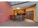 Resident bar and kitchen with bar-style seating and wood cabinetry at 1425 Blue Sky Cir # 15-107, Erie, CO 80516
