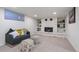 Finished basement features neutral carpet, recessed lighting, painted stone fireplace, and a comfy couch at 8481 Clarkson St, Denver, CO 80229