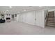 Spacious basement features neutral carpet, recessed lighting, and painted stone fireplace with built-in shelving at 8481 Clarkson St, Denver, CO 80229