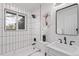 Modern bathroom with white subway tile, black hardware, and a soaking tub with shower at 8481 Clarkson St, Denver, CO 80229