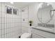 Stylish bathroom features tiled shower, mosaic tile floor, modern fixtures, and integrated sink at 8481 Clarkson St, Denver, CO 80229