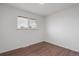 Empty bedroom with hardwood floors and window overlooking the yard at 8481 Clarkson St, Denver, CO 80229