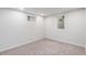 Neutral bedroom features two windows, neutral carpet, and white walls at 8481 Clarkson St, Denver, CO 80229