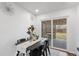 Dining area featuring a modern table and chairs with sliding glass doors that lead to a deck at 8481 Clarkson St, Denver, CO 80229