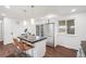 Bright open kitchen with breakfast bar, stainless steel appliances, and view to breakfast area at 8481 Clarkson St, Denver, CO 80229