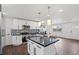 Well-lit kitchen with stainless steel appliances, island with pendant lights, and tiled backsplash at 8481 Clarkson St, Denver, CO 80229