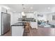 Bright kitchen with modern appliances, island, and open floor plan flowing into the living room at 8481 Clarkson St, Denver, CO 80229