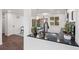 Kitchen with black marbled countertops, modern faucet, stainless sink, and view of breakfast area at 8481 Clarkson St, Denver, CO 80229