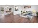 Bright living room featuring hardwood floors, stylish furniture, and an open layout to the kitchen area at 8481 Clarkson St, Denver, CO 80229