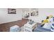 Open-concept living room featuring hardwood floors, stylish furniture, and access to other rooms at 8481 Clarkson St, Denver, CO 80229