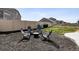 Private backyard featuring a stone fire pit, seating, and a well-maintained fence at 5352 Truckee St, Denver, CO 80249