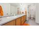 Bright bathroom featuring double sinks with wood cabinets and colorful decor at 5352 Truckee St, Denver, CO 80249