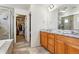 Bright bathroom features double sinks, granite countertops, and a glass-enclosed shower at 5352 Truckee St, Denver, CO 80249
