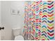 Colorful bathroom with geometric-themed shower curtain and decorations at 5352 Truckee St, Denver, CO 80249