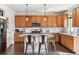 Bright kitchen with granite countertops, center island, stainless steel appliances and wood cabinetry at 5352 Truckee St, Denver, CO 80249